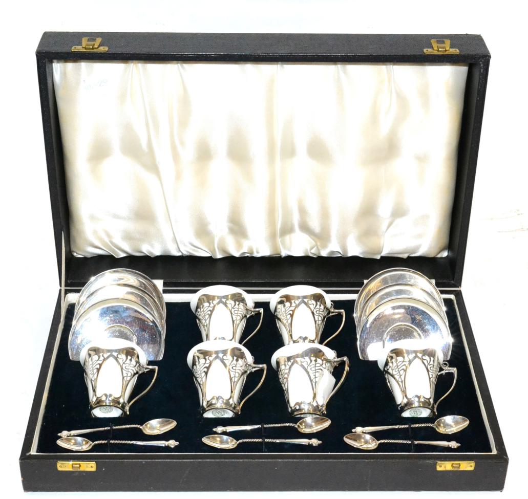 An Art Nouveau Royal Doulton and Silver Coffee Set, by Roberts & Belk, with six white glazed cans