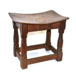 A Robert ''Mouseman'' Thompson Burr Oak Dish Top Stool, the adzed top on four octagonal legs