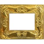 An Arts and Crafts Brass Wall Mirror, circa 1900, of rectangular form, the frame repousse