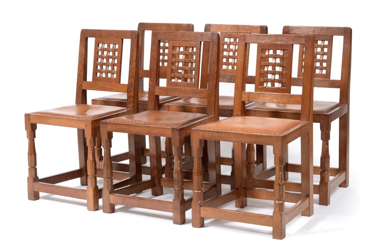 A Set of Six Robert ''Mouseman'' Thompson Oak Lattice Back Dining Chairs, with cow hide