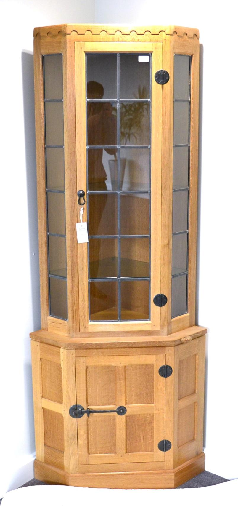 A Robert ''Mouseman'' Thompson Oak Corner Display Cabinet, penny moulded frieze, the upper section