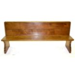 A Robert ''Mouseman'' Thompson Oak 6ft 1'' Pew, with book rest, on two shaped supports, with