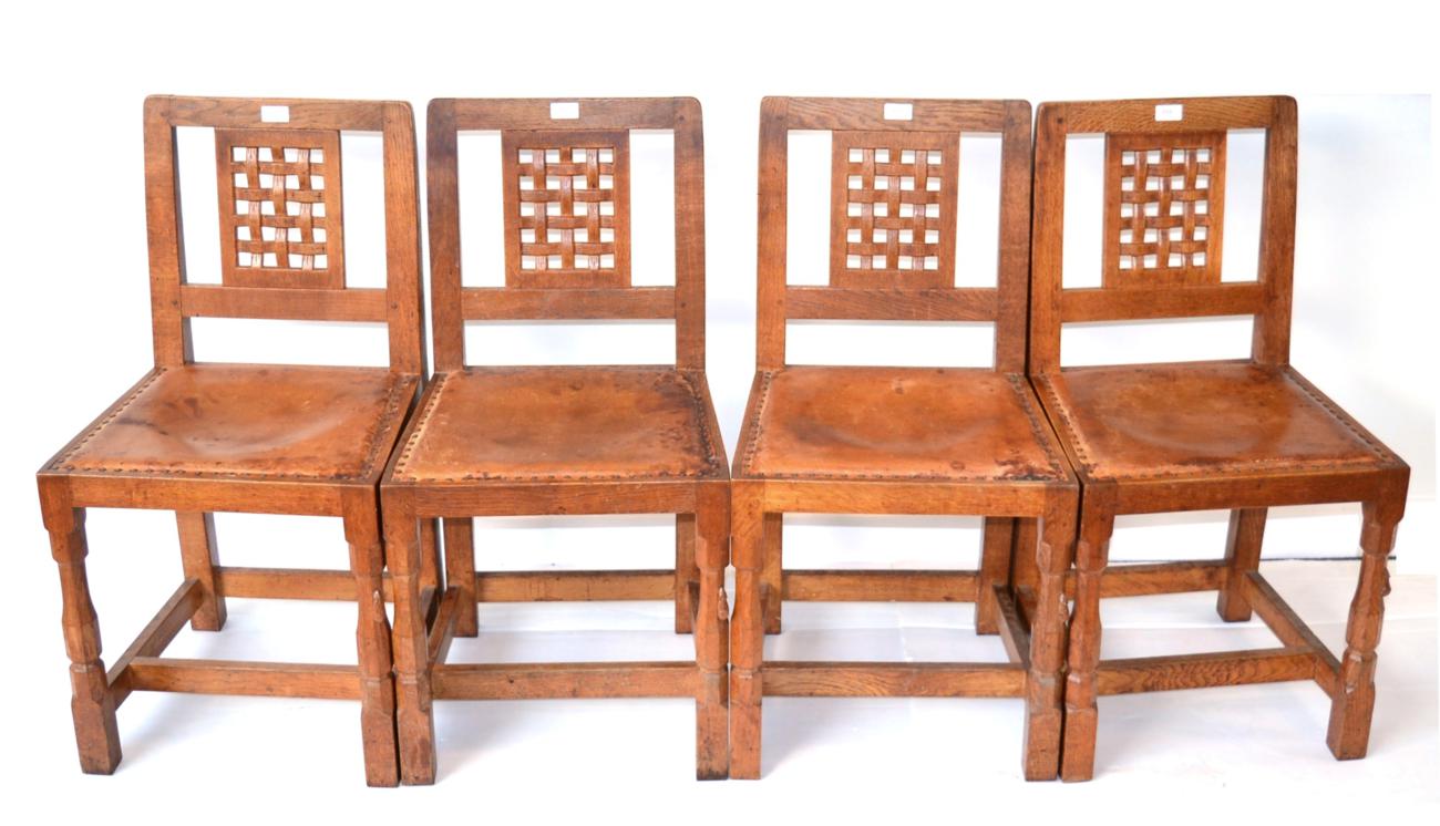 A Set of Four Robert ''Mouseman'' Thompson Oak Lattice Back Dining Chairs, with cow hide upholstered