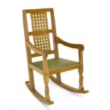 A Robert ''Mouseman'' Thompson Oak Rocking Chair, with two lattice back panels, shaped arms, green