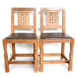 A Set of Four Robert ''Mouseman'' Thompson Oak Lattice Back Dining Chairs, with dark cow hide