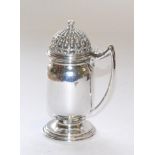 An Arts & Crafts Mustard Pot, by Omar Ramsden, London, 1938, hammered finish, with architectural