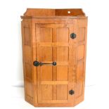 A Robert ''Mouseman'' Thompson Panelled Oak Hanging Corner Cupboard, the single door opening to