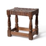 A Robert ''Mouseman'' Thompson Oak Stool, with lattice leather top, on four octagonal legs joined by