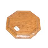 A Robert ''Mouseman'' Thompson Oak Small Chopping Board/Teapot Stand, of octagonal form, with carved