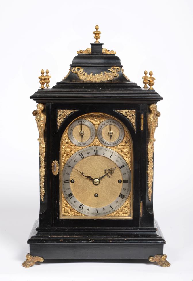 An Ebonised Chiming Table Clock, circa 1890, inverted bell top with urn finials, side carrying