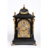 An Ebonised Chiming Table Clock, circa 1890, inverted bell top with urn finials, side carrying