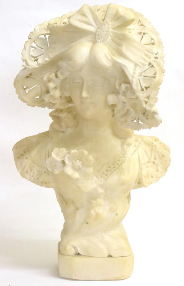 A Palechi: An Alabaster Bust of an Art Nouveau Maiden, wearing a ribbon tied bonnet and lacy dress