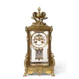 A Brass Four Glass Striking Mantel Clock, circa 1890, urn shaped finial, bevelled glass panels,