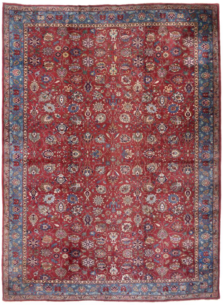 Indo-Tabriz Carpet The aubergine field with an allover design of palmettes and flowerheads