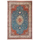 Ghom Silk Rug Central Iran The green/blue field of scrolling vines around an ivory pole medallion