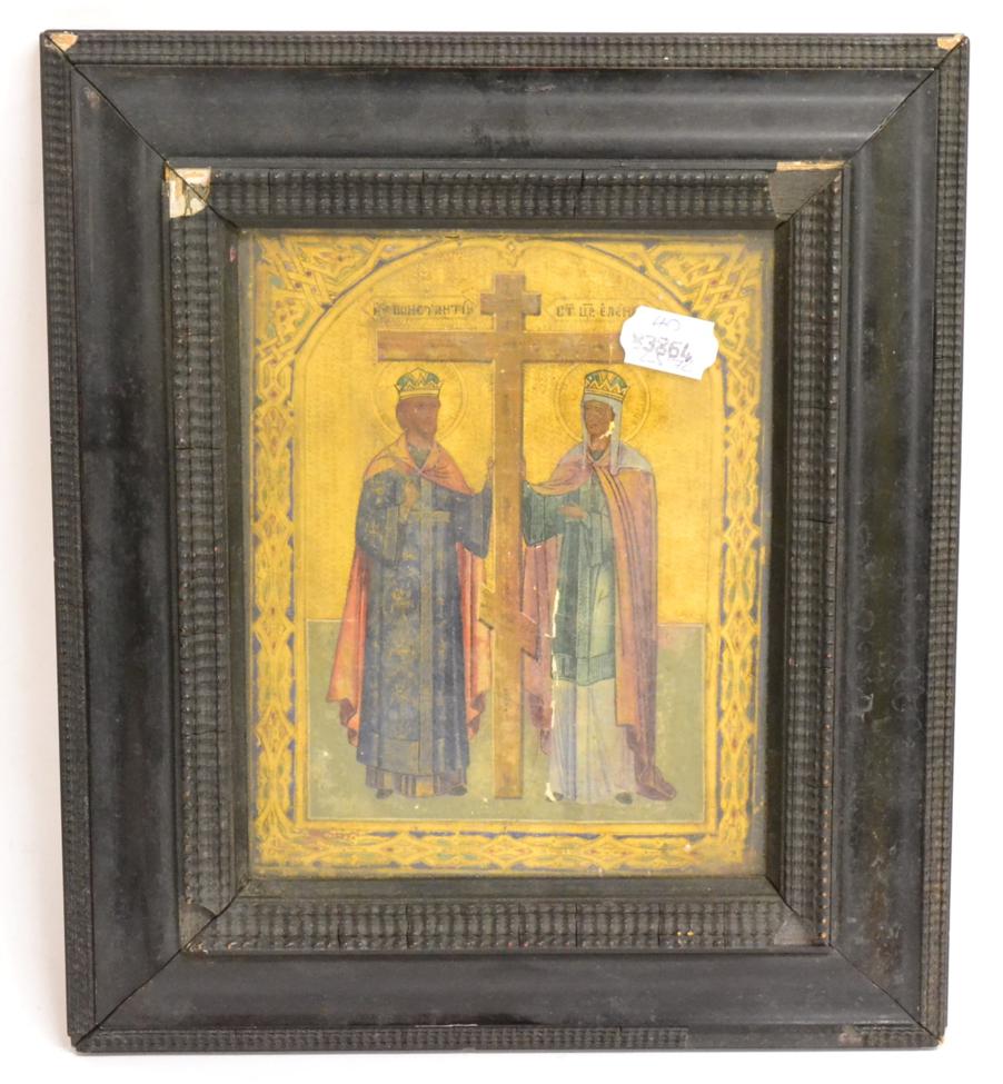 A Russian Icon, 19th century, painted with the Cross flanked by two saints on a gold ground with