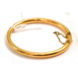 A hinge opening bangleThe bangle is not hallmarked or stamped but in our opinion would test as gold.