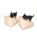 Pair of cold painted bronze terriers mounted on alabaster bookends, together with a similar pair (