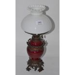 A 19th century metal mounted oil lamp with opaque shade
