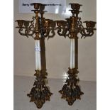 A pair of French gilt metal and glass candlesticks