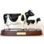 Beswick Friesian Cow and Calf, model No. 1362/1249C, on wooden plinth, black and white gloss