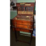 A 1930's oak canteen of plated flatware on oak barley twist stand