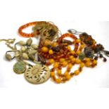 A faceted amber bead necklace, a simulated amber and filigree necklace and earrings suite, a