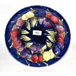 A William Moorcroft Wisteria pattern bowl, impressed factory mark, blue painted signature