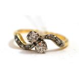 A diamond two stone twist ring Finger size M1/2, 2.26g gross.