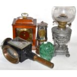 A 19th century oil lamp, carriage lamp, miners lamp, glass dump paperweight and mantel timepiece