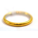 A band ring stamped '22CT'Finger size K1/2, 3.18g gross.