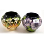 Two modern Moorcroft vases, 'Petunia' and 'Scrambling Lily' pattern, both 11cm high (boxed)Both in