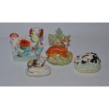 Four 19th century Staffordshire models including rabbit, cat etc