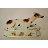 A 19th century Staffordshire model of a recumbent hound