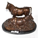 A bronze group of cattle, oval marble base