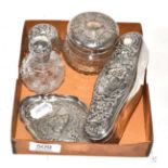 A silver dressing table box, three silver mounted glass bottles and tray