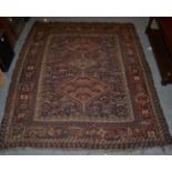 Khamseh rug, circa 1900, the indigo field of stylised chickens around three stepped medallions