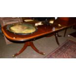 A reproduction mahogany, satinwood banded and boxwood strung twin-pedestal dining table in Regency