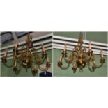 A pair of brass Flemish style six branch chandeliers
