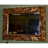A gilt composition mirror