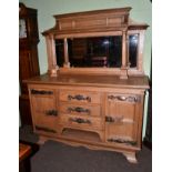 An early 20th century oak mirror backed sideboard in the Arts & Crafts taste