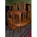An oak extending table with six matching chairs upholstered in close nailed leather