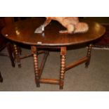 An 18th century gateleg dining table with boldly turned legs