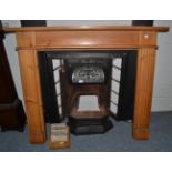 A Victorian fireplace with pine surround and tiled insert