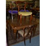 An extending dining table and nine chairs