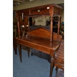 An early Victorian mahogany side table, with architectural pediment above a plain frieze, raised