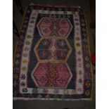 An Anatolian Kilim, the field with three hexagonal enclosed by double borders, 138cm by 100cm