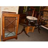 A group of furniture comprising a twin pedestal dining table, a glazed walnut display cabinet, a