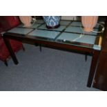 A frosted glass top dining table of recent date, the rectangular top raised on square form legs,