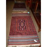 A Balouch rug, West Afghanistan, the field centred by a shaped panel enclosed by geometric